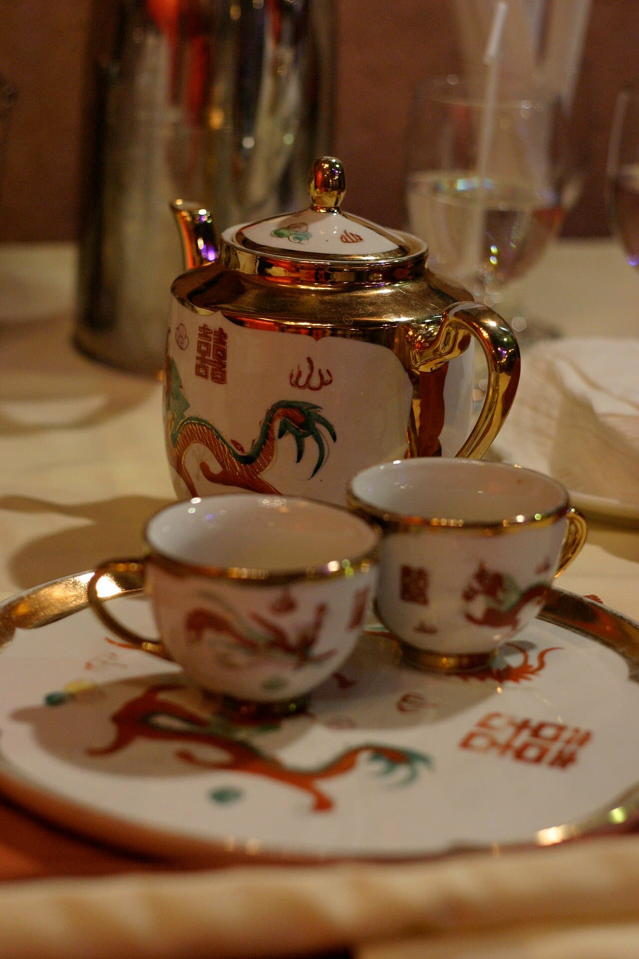 Hands serving tea during a Chinese wedding tea ceremony