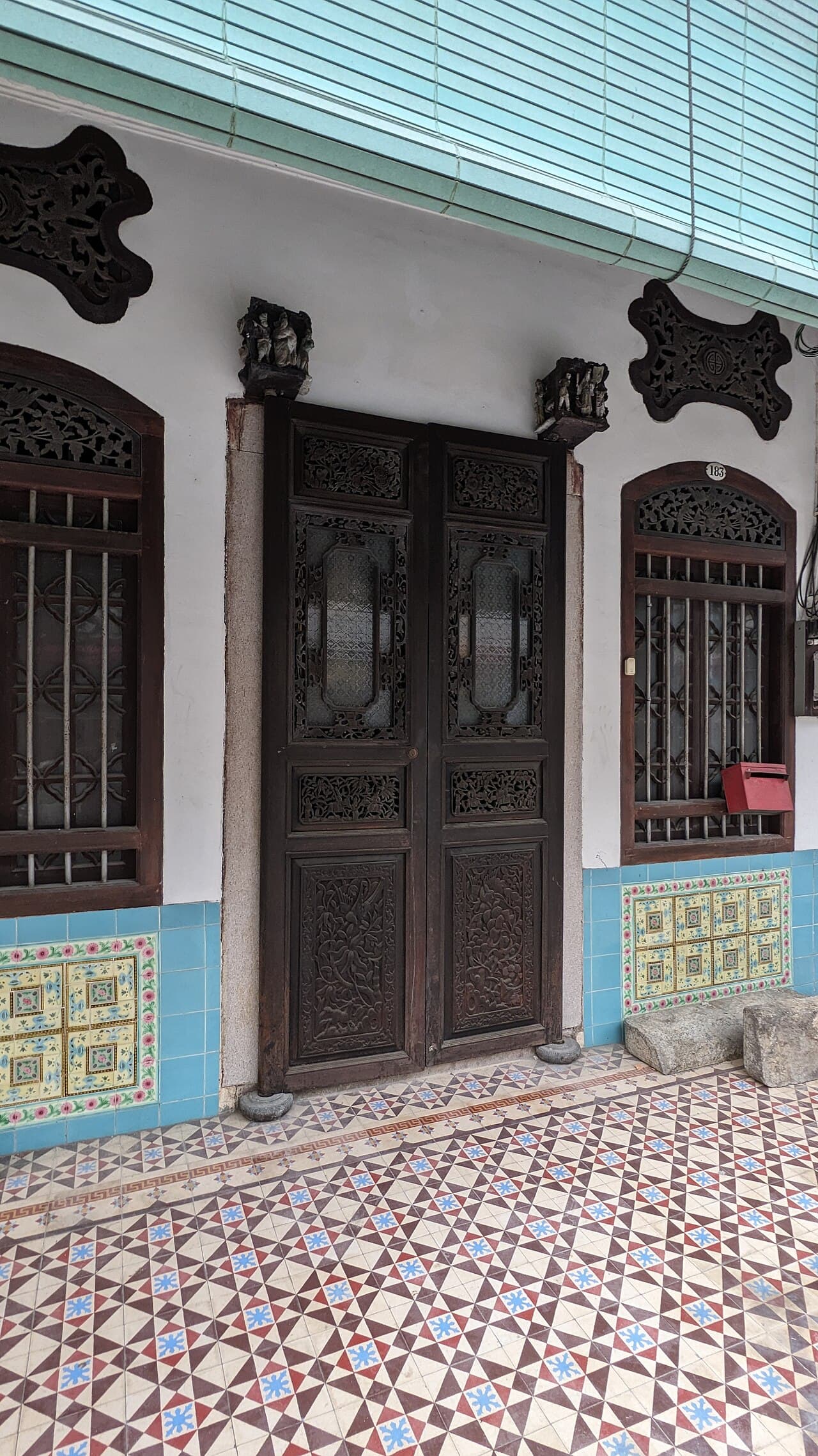 Carved wooden doors on a heritage shophouse in George Town, Penang